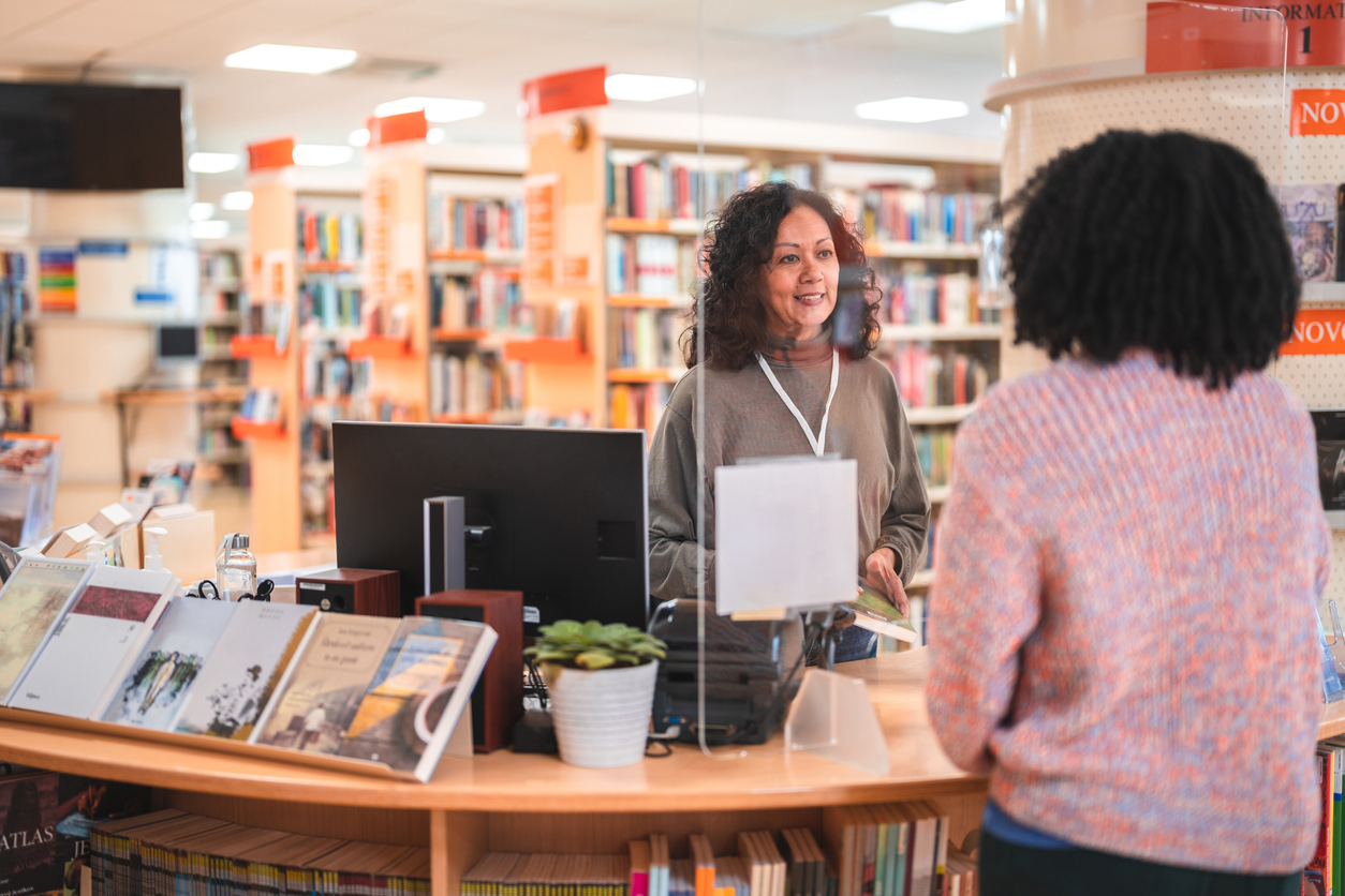 iStock-1455947949 save money gardening lati female librarian helping a patron