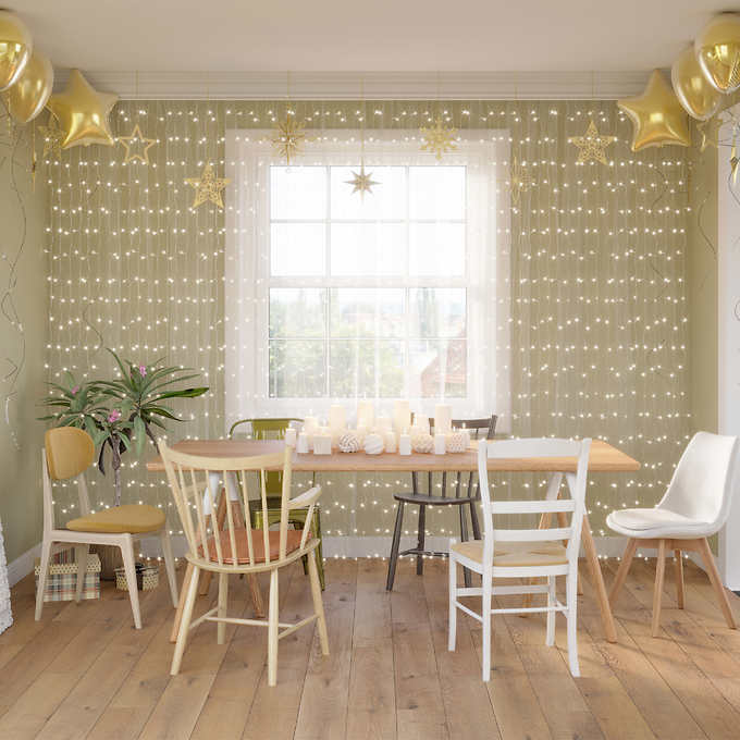 string lights hanging in front of window in kitchen party scene