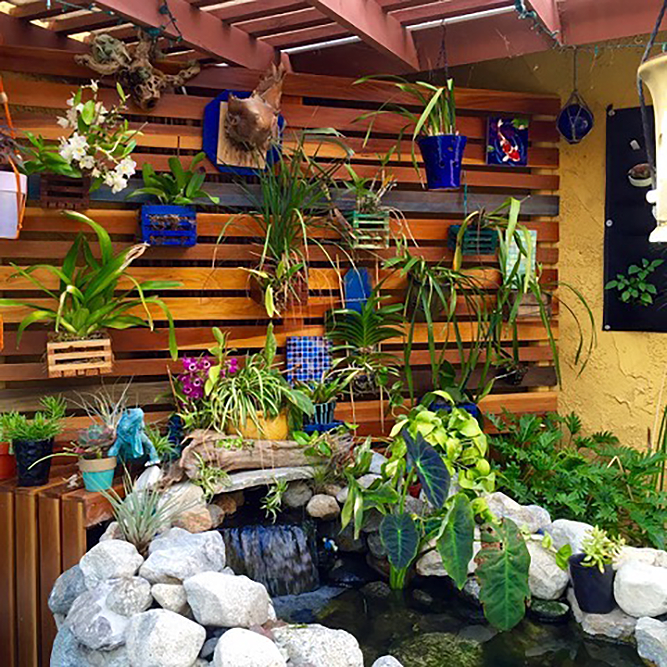 orchid wall vertical garden with wood slats and planters attached to the wall