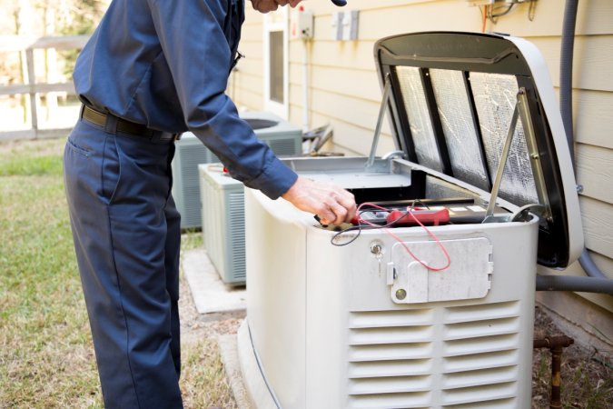 A professional technician is working on a home generator.