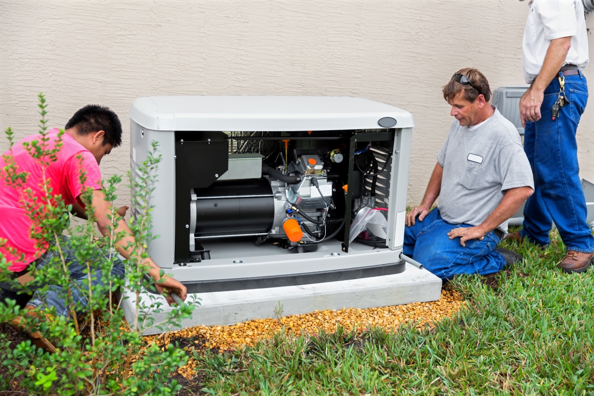 Multiple technicians working on a home generator.