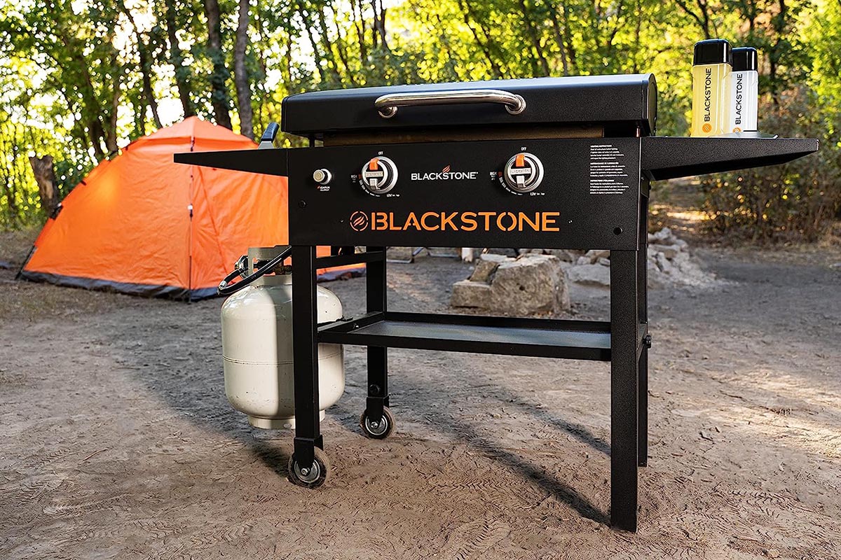 Blackstone griddle at a campsite in front of orange tent