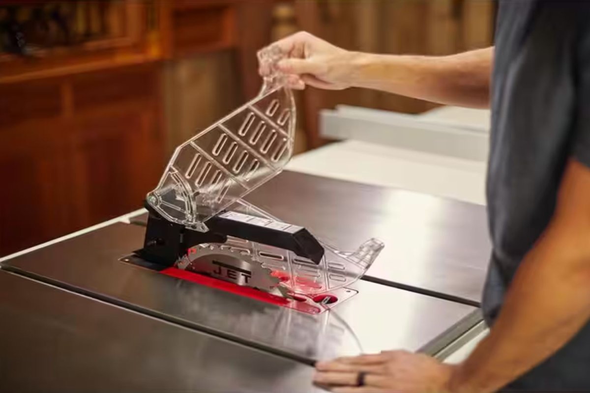 Someone using a table saw in a workshop