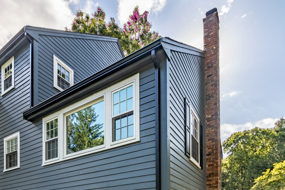 house with dark blue Hardie Board siding and white trim