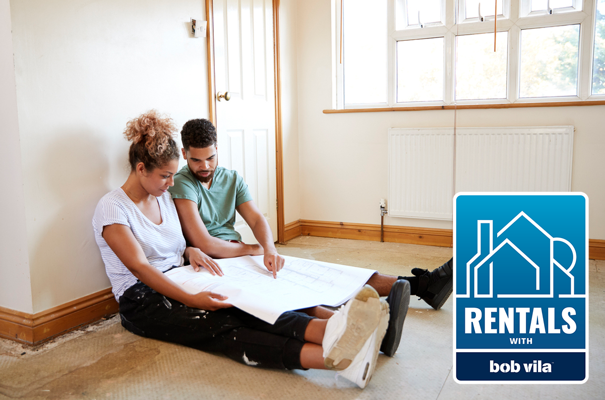 young couple sitting on the floor debating what updates to ask landlord to make