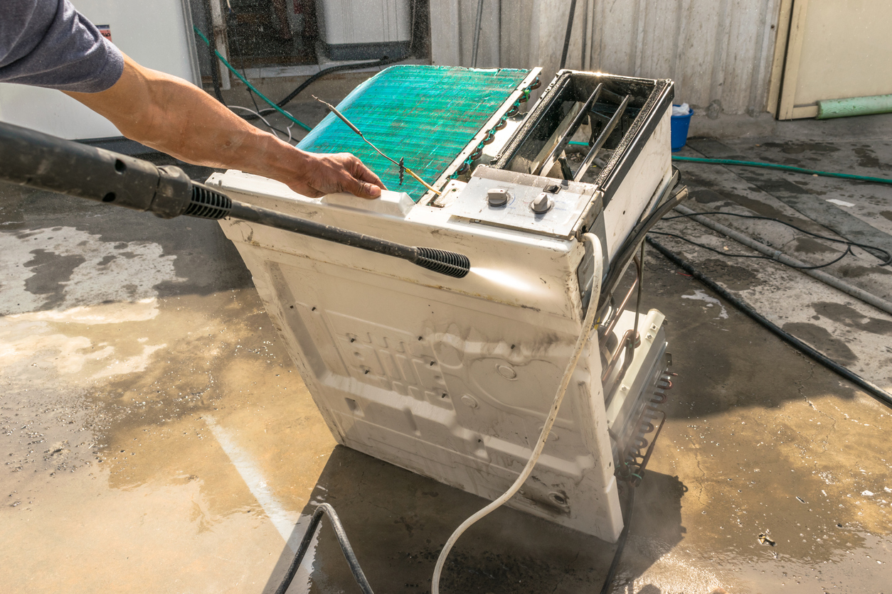 close up of power washing air conditioner