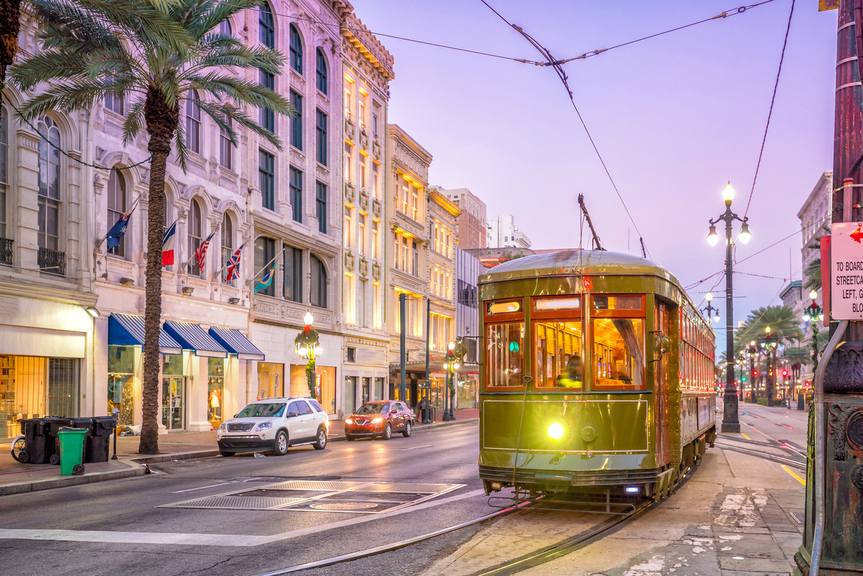 new orleans louisiana streetcar downtown palm trees sunset