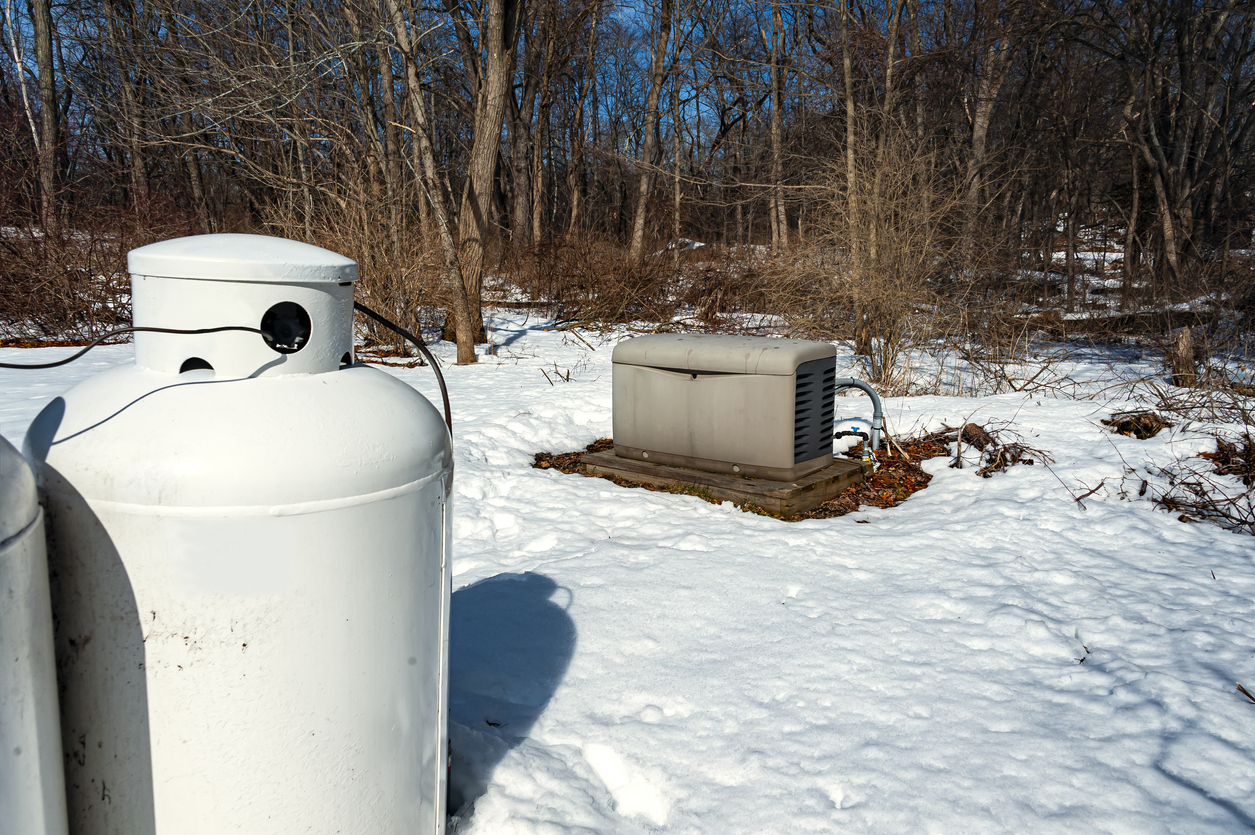 iStock-1271832115 standby generator generator with propane tanks in foreground