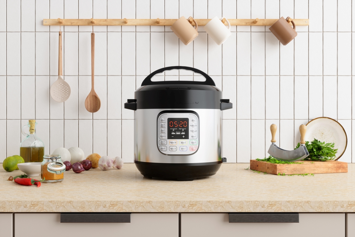 Slow cooker in a modern kitchen with white subway tile in the background.