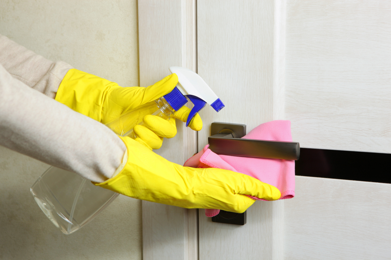 dusting and disinfecting doorknob