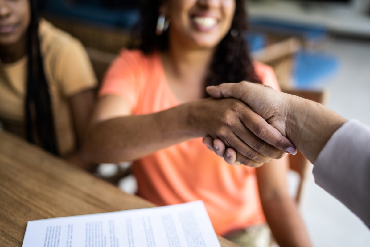 residential rental property - woman shaking someones hand