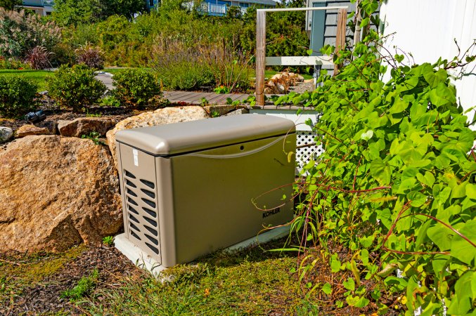 home standby generator outside of home on concrete pad waiting for annual generator maintenance