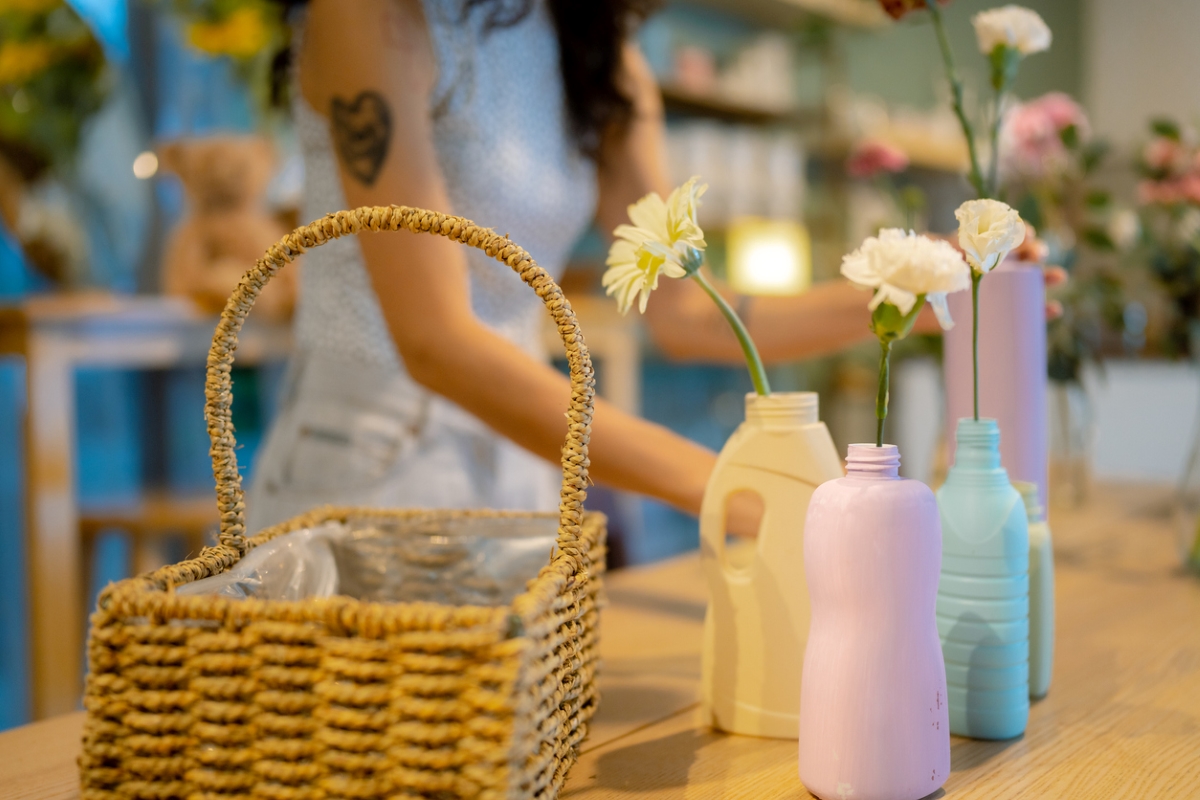 Plastic bottles reused as vases holding single carnations