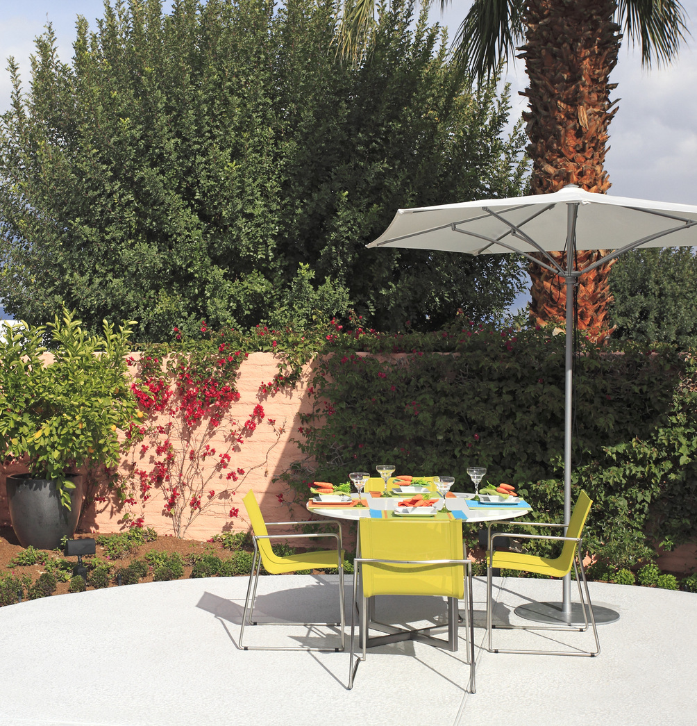 outdoor dining table in patio backyard with white umbrella