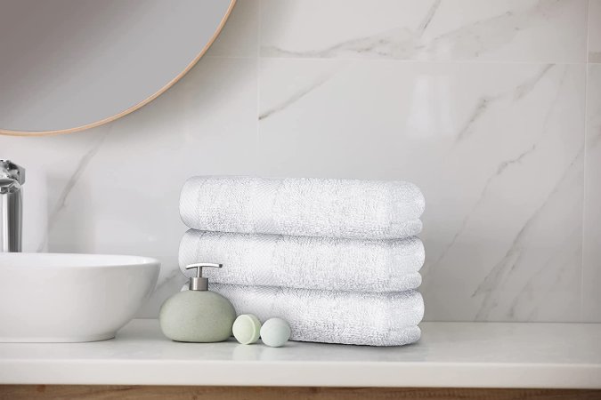 The Best Hand Towels option neatly folded and stacked next to a bathroom sink