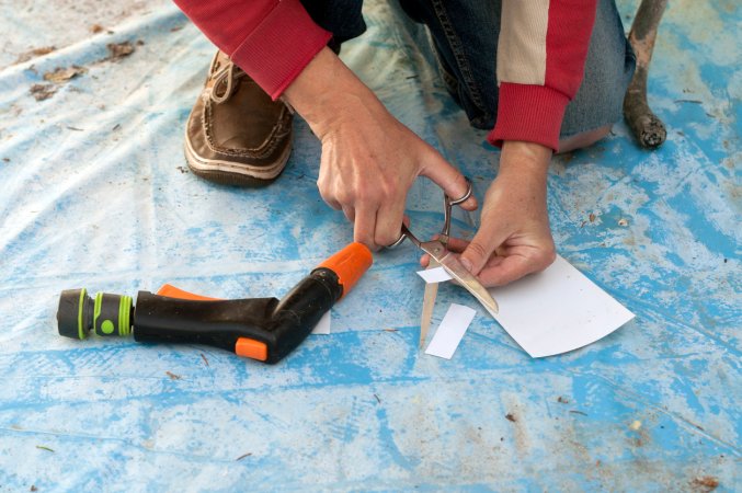 The Best Pool Patch Option being cut to size next to a heat gun