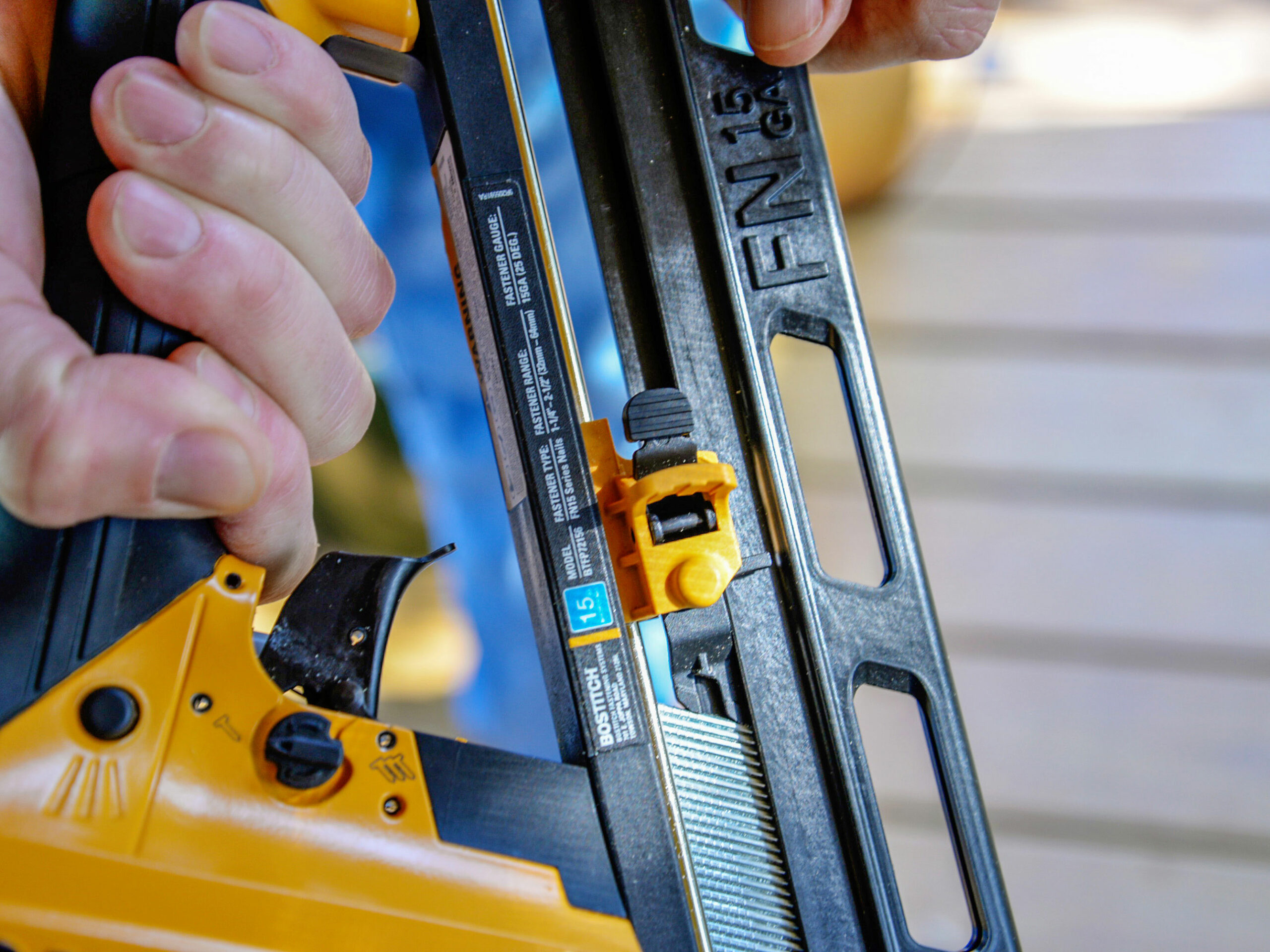 Person using finish nailer on floor boards