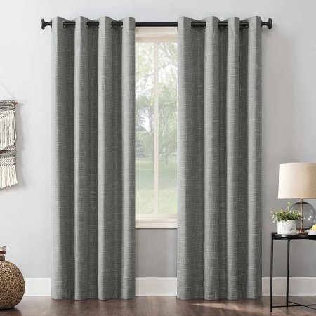  A grey set of Abihail Burlap Weave Thermal Extreme Blackout Curtains installed on a over a large window in a living room.