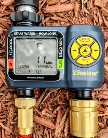 Melnor dual zone hose timer on cedar mulch