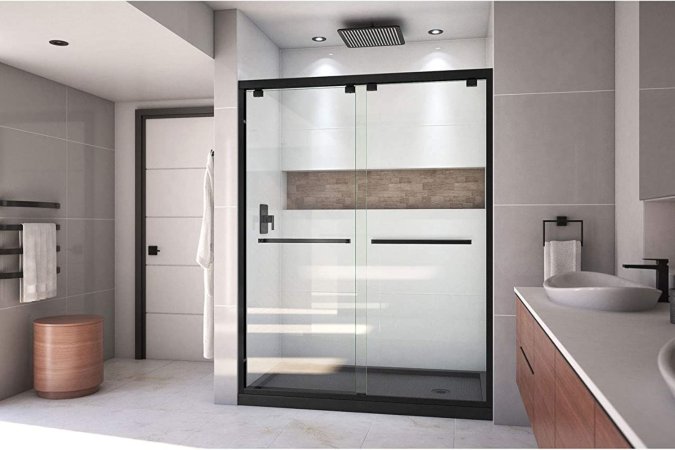 A large shower door in a bright bathroom