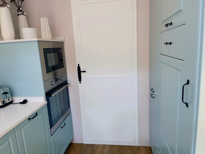 light-blue-kitchen-with-white-pantry-door