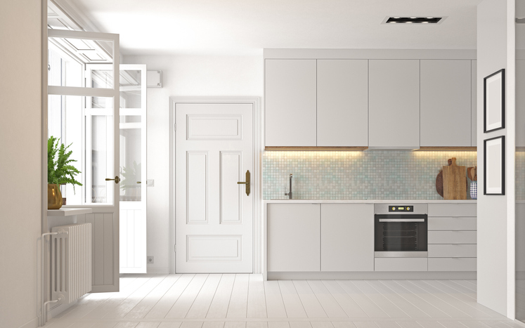 white-modern-kitchen-with-French-doors-to-outside-and-a-paneled-wood-pantry-door