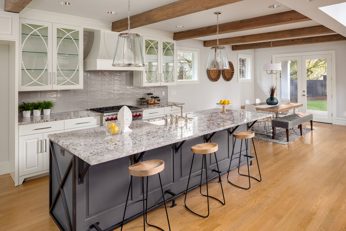 open concept kitchen with marble countertop on kitchen island