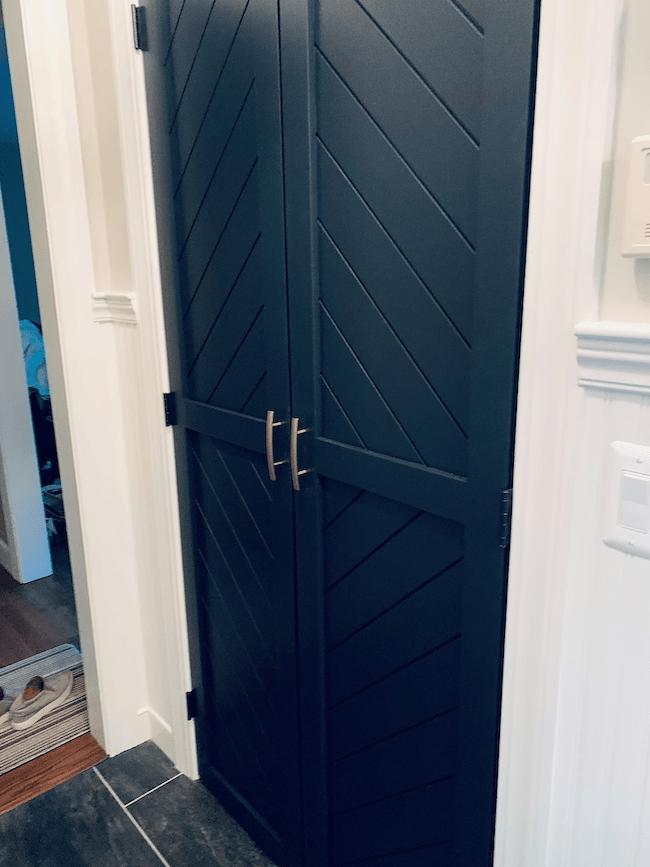 dark-blue-barn-door-style-doors-on-a-closet-pantry