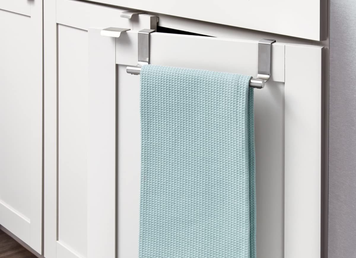 Blue dishtowel on over the cabinet hook on a white cabinet