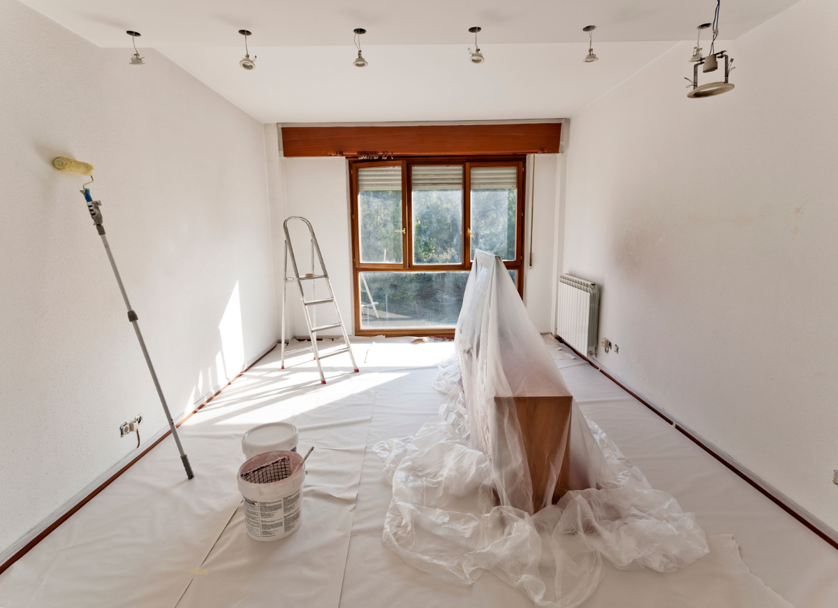 Painting tools in an empty room, ready for painting