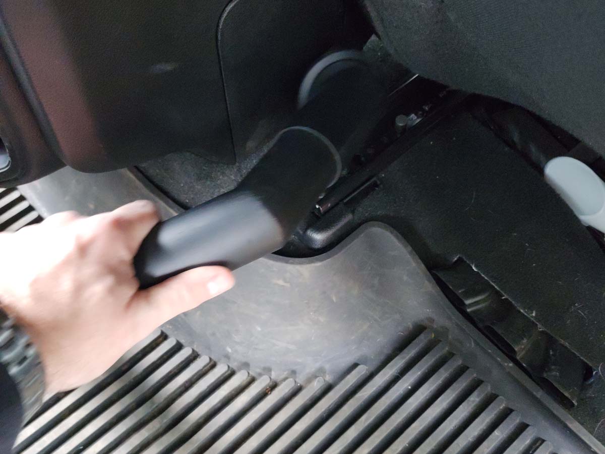 Man using the DeWalt Wet Dry Vac on car floor