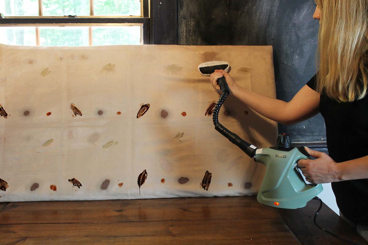 A testing board showing the results of many handheld steam cleaners' ability to remove various stains