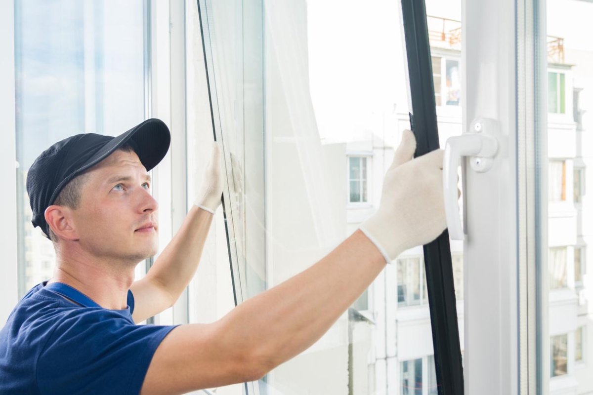 A worker replaces a window.