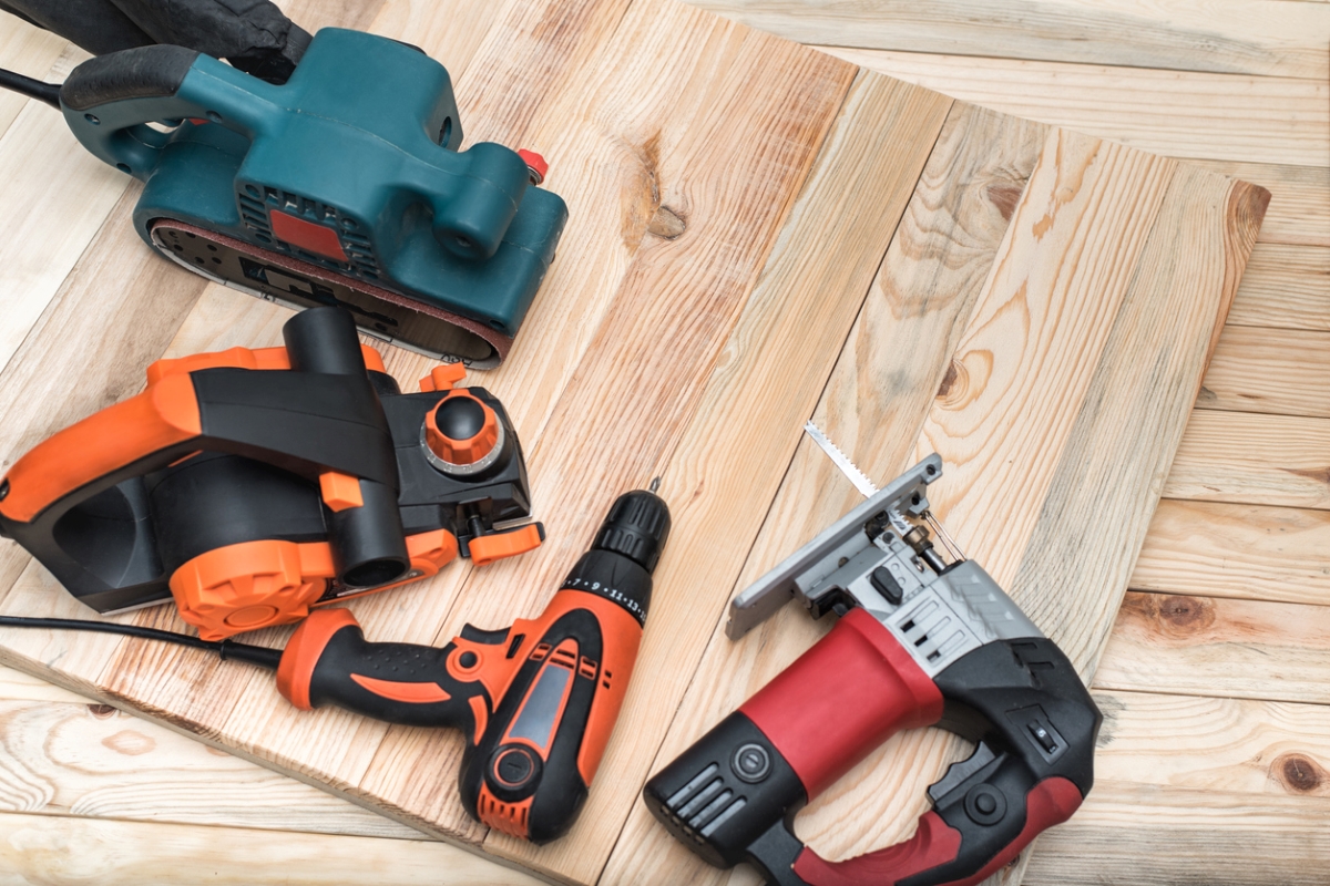 Multiple power tools on wooden table