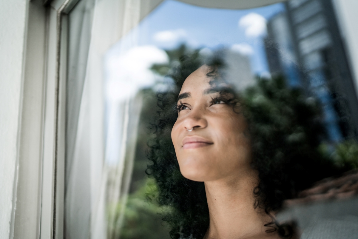 Woman looking outside window