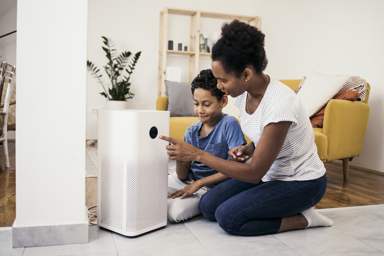 African American woman and her son setting up the intelligent home system on a smartphone.