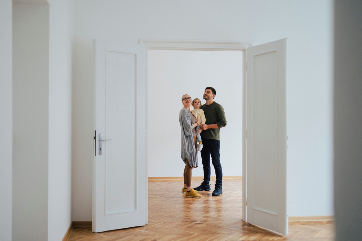 Family standing in empty home