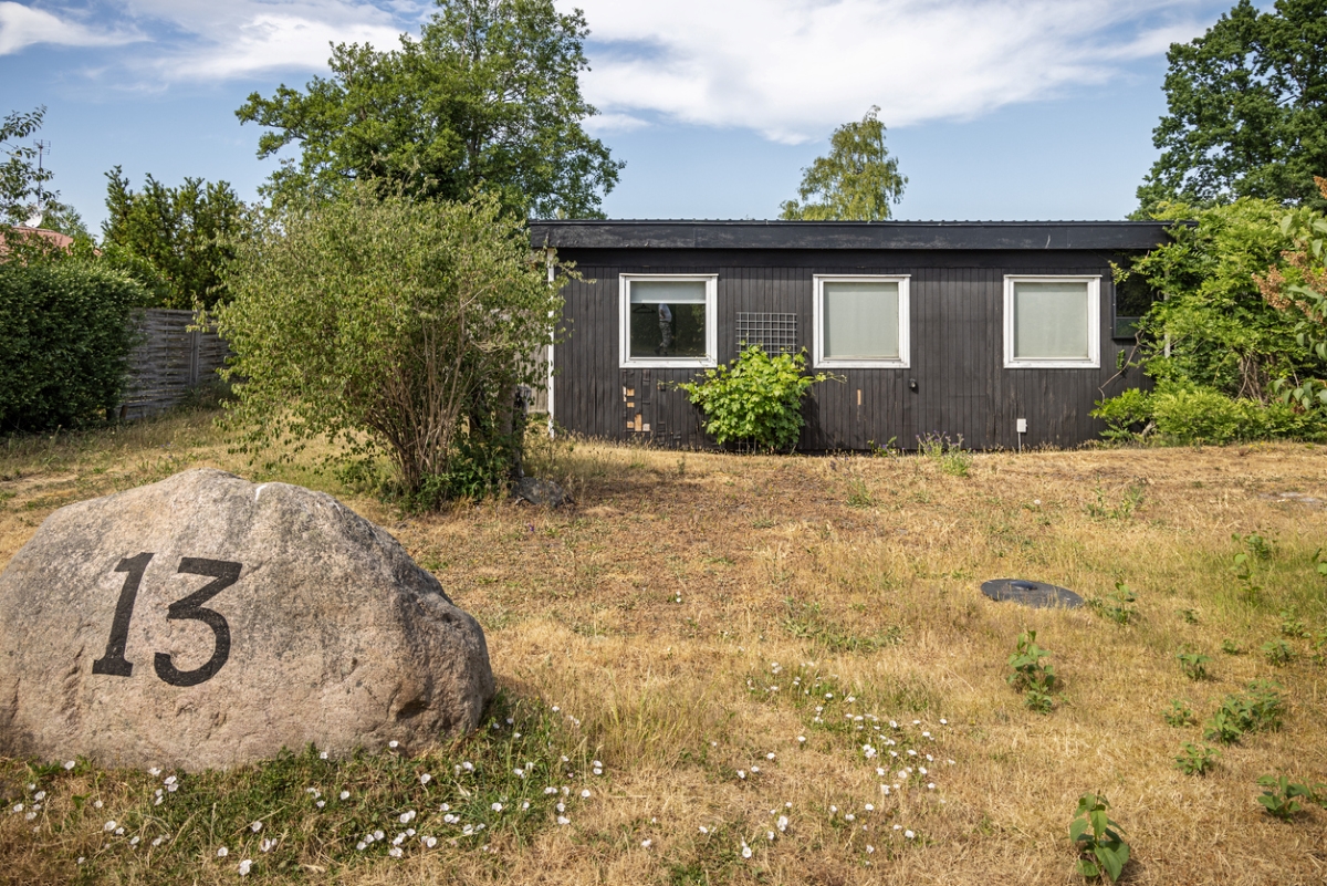 House number on rock in front of house