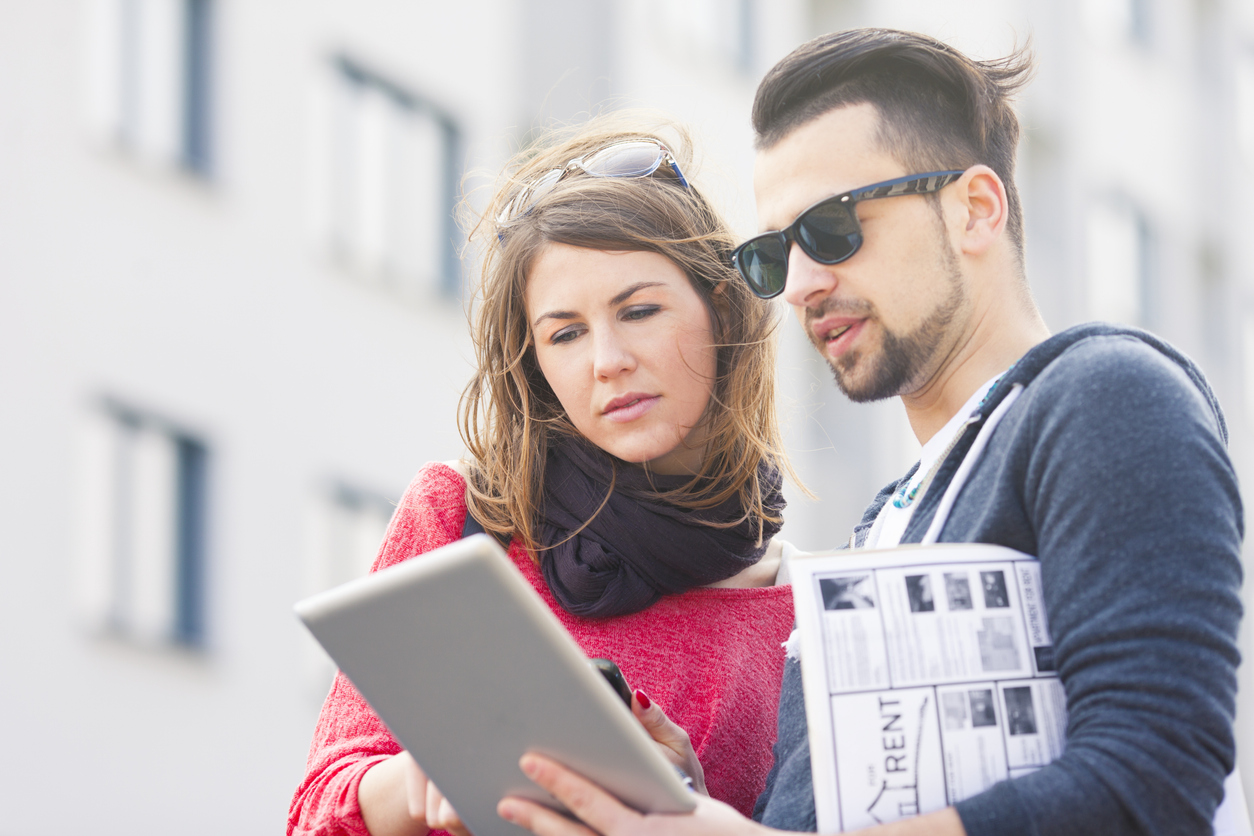 couple checking home listings on iPad