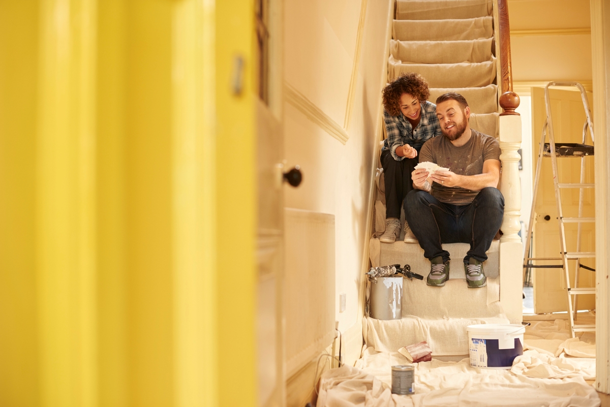 View of couple from doorway working on home project