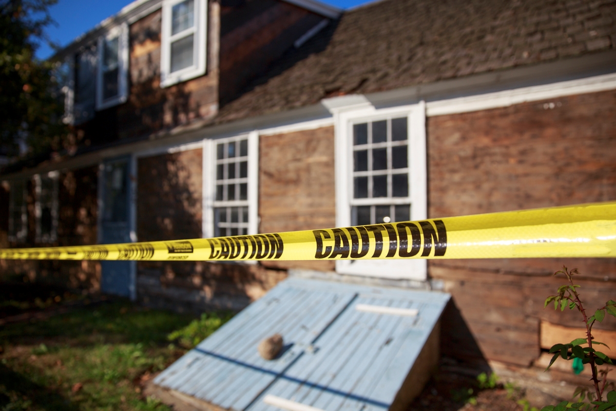 Caution tape wrapped around home exterior