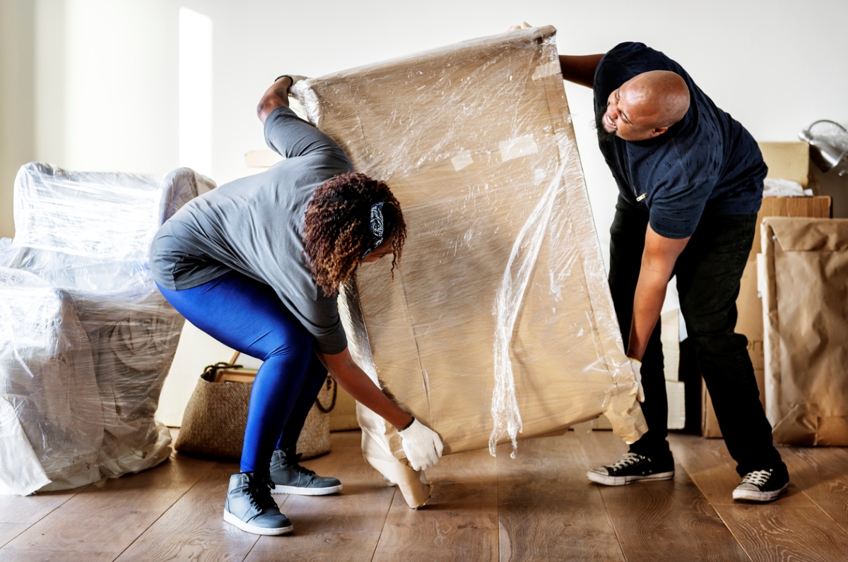 Couple lifting large box