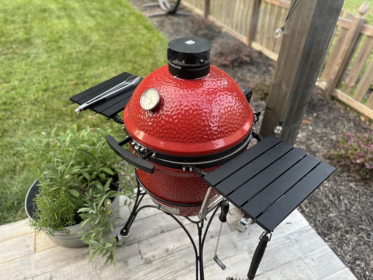 The Kamado Joe Classic Joe Grill on the corner of a deck