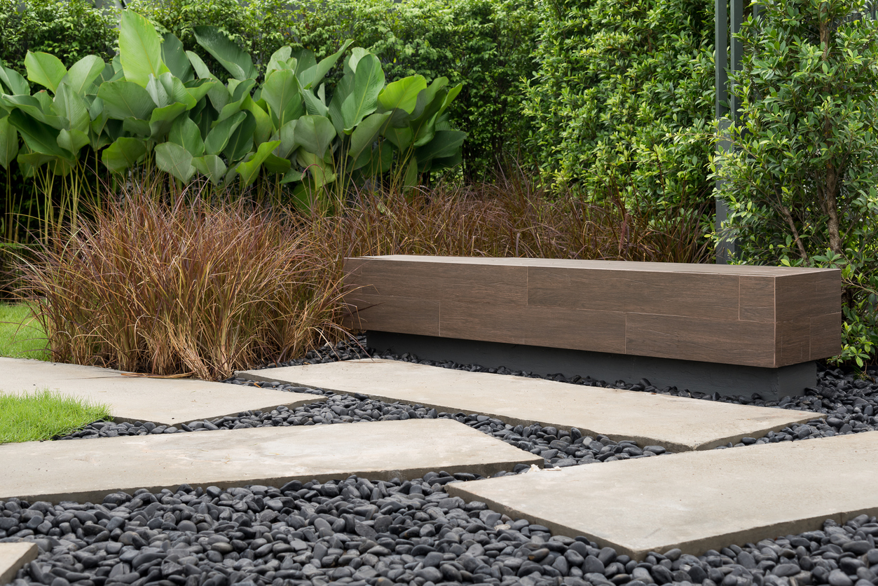 A minimalistic stone garden bench in a modern courtyard.