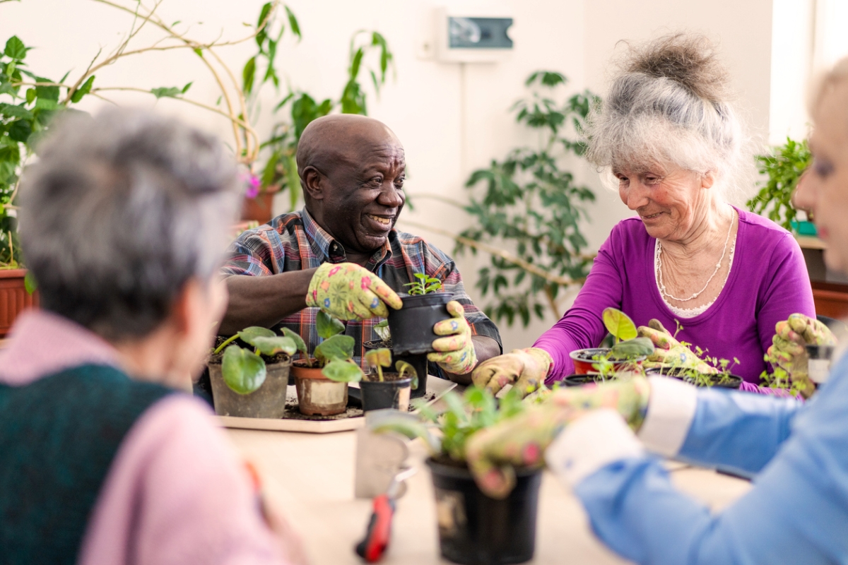 People sharing plants and smiling