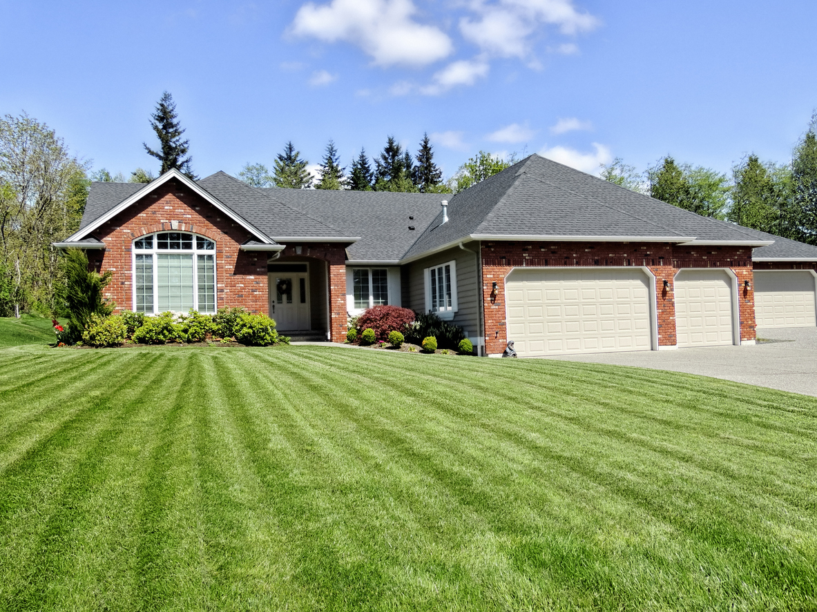 red-brick-house-with-a-green-freshly-mowed-lawn