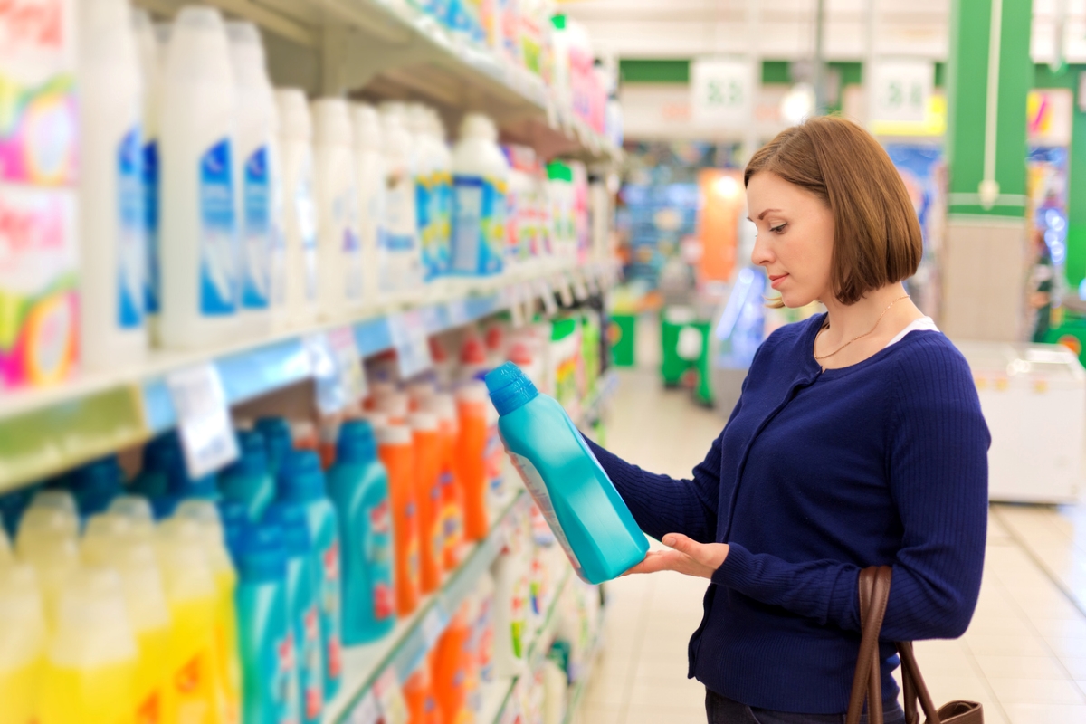 Woman looking at laundry detergent at store