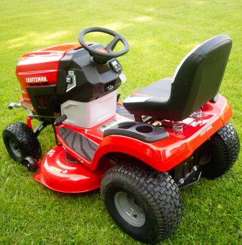 The Craftsman battery riding mower parked on a freshly mowed lawn