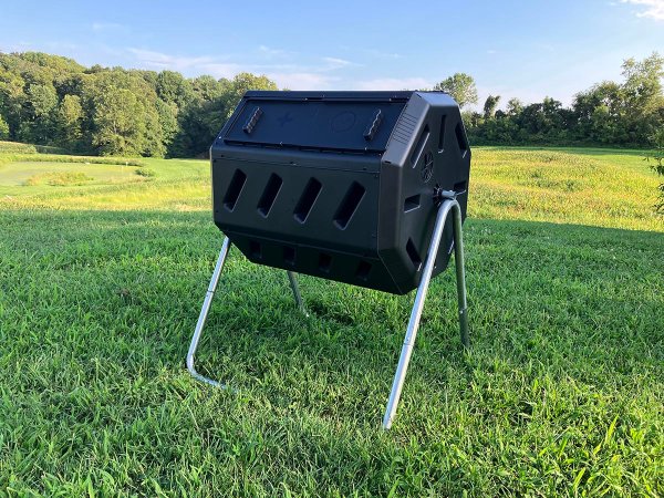 The FCMP Outdoor tumbling composter set up in a yard