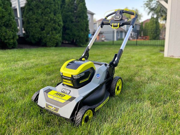 The Ryobi 21-inch self-propelled all-wheel-drive mower on a neatly trimmed lawn